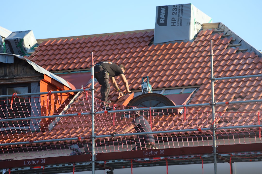 A man on a roof working on a roof A man on a roof working on a roof