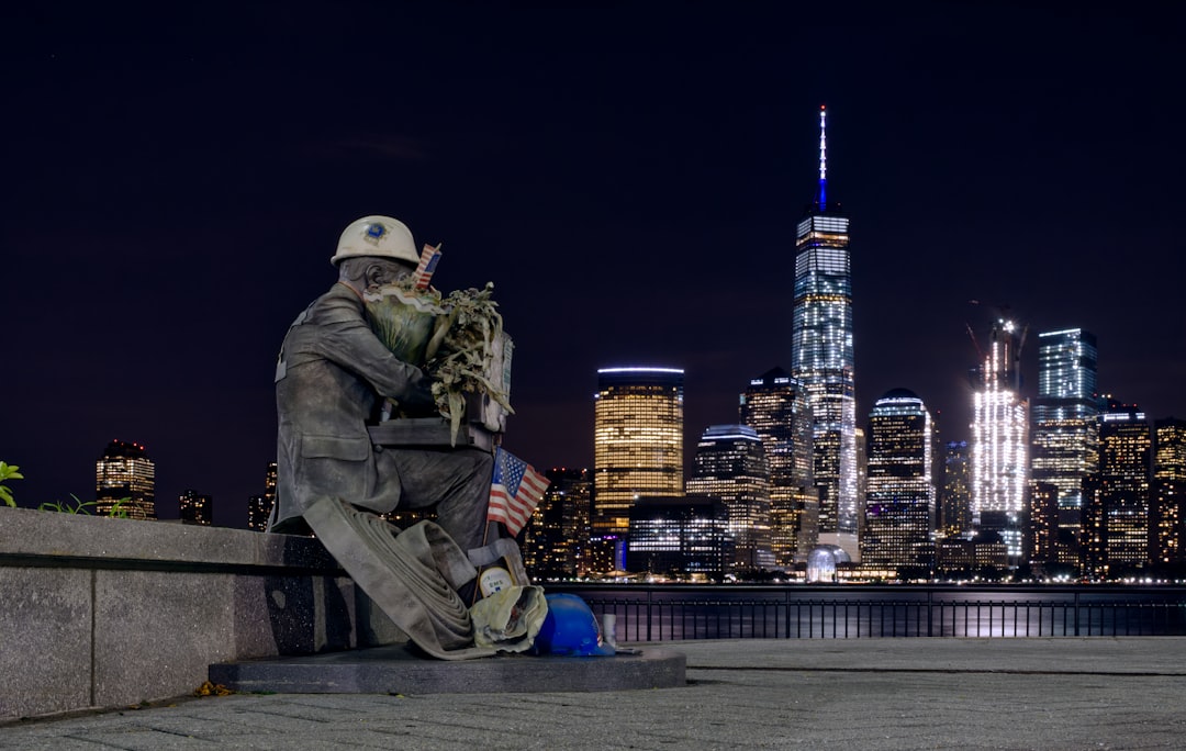 man in green camouflage uniform sitting on brown wooden bench