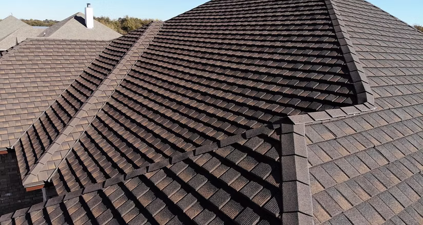Stone-coated-metal-roofing-1024x767 A man on a roof working on a roof