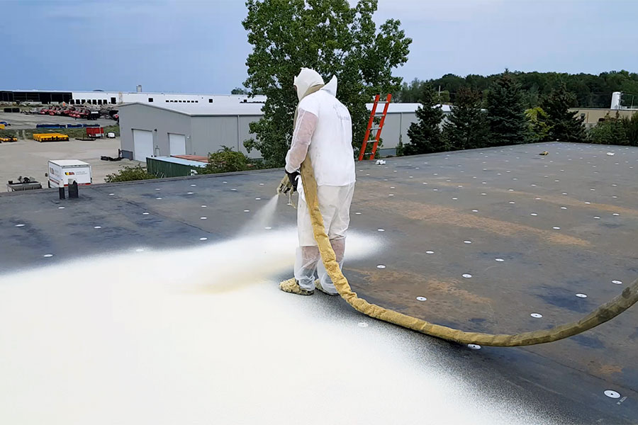 spray-foam-roofing-installation-hdr-img A man on a roof working on a roof